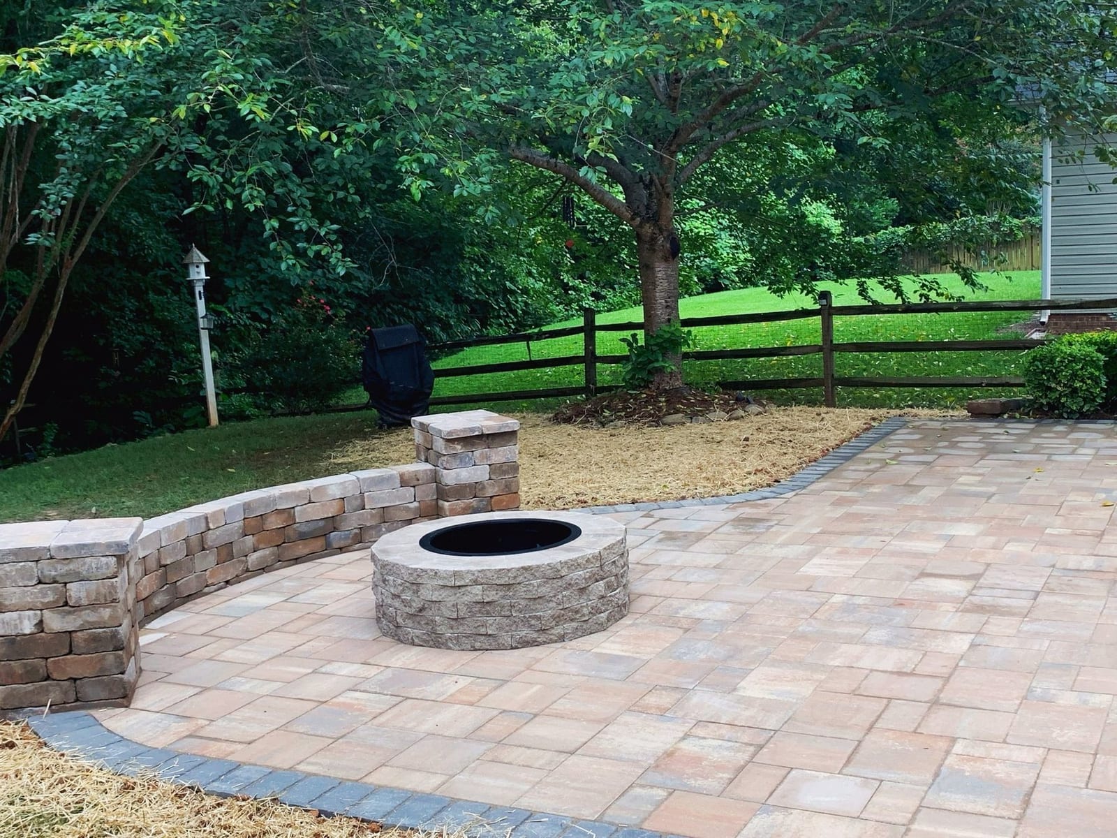Fire pit ringed by a stone seat wall