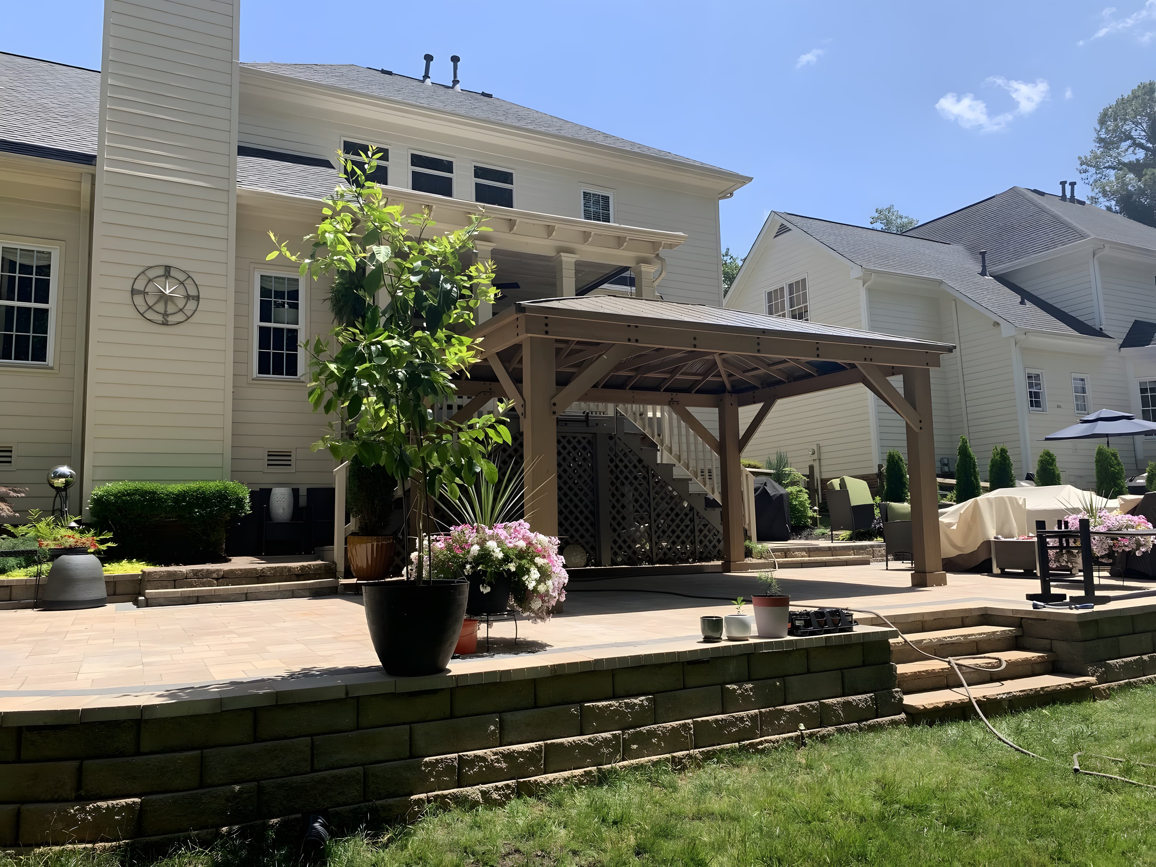 Pergola over a paver patio with stone seating walls